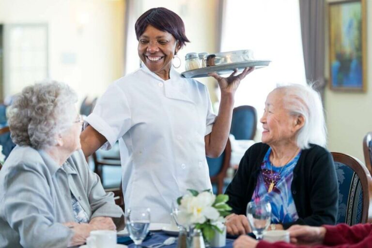 great place to work team member serving seniors at dinner